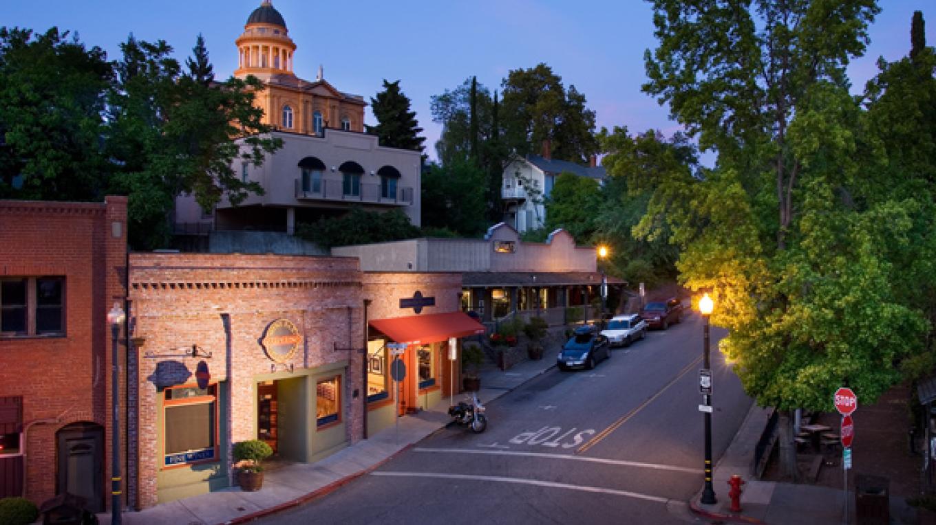 Historic downtown Auburn, California at dusk with the domed Placer County Courthouse on the hillside